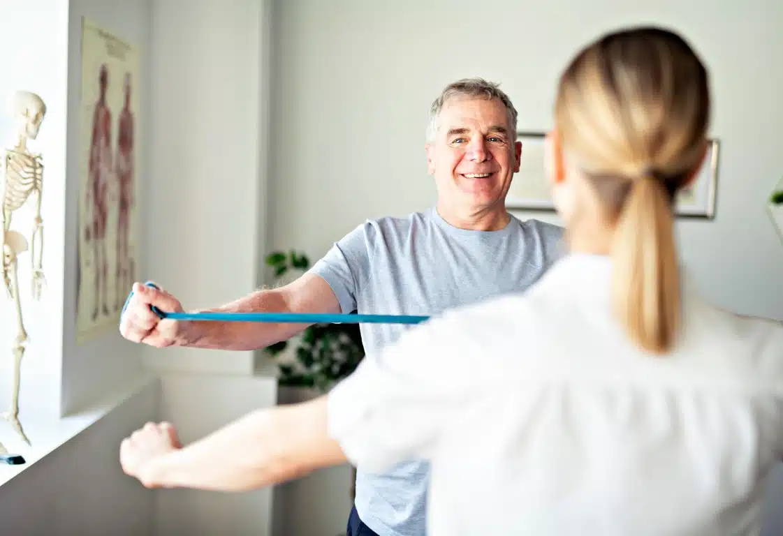 Physiotherapy Therapist With Client Stretching